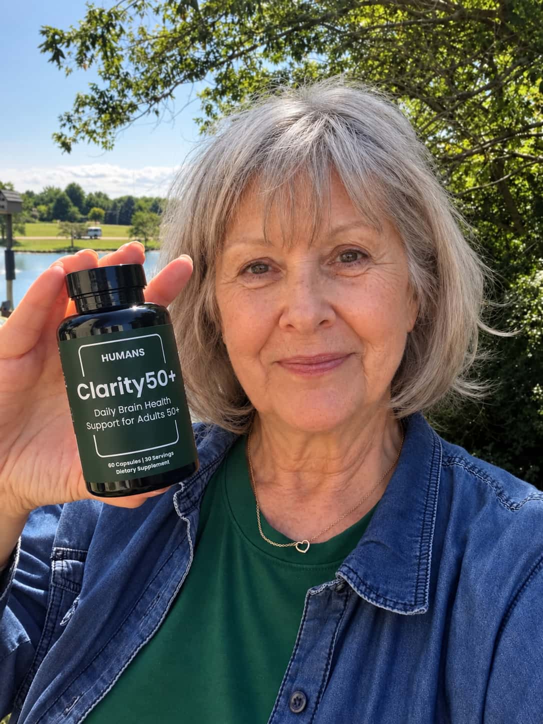 Joanne holding her bottle of Clarity50+ outside
